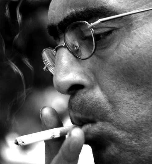 stressed man smoking a cigarette